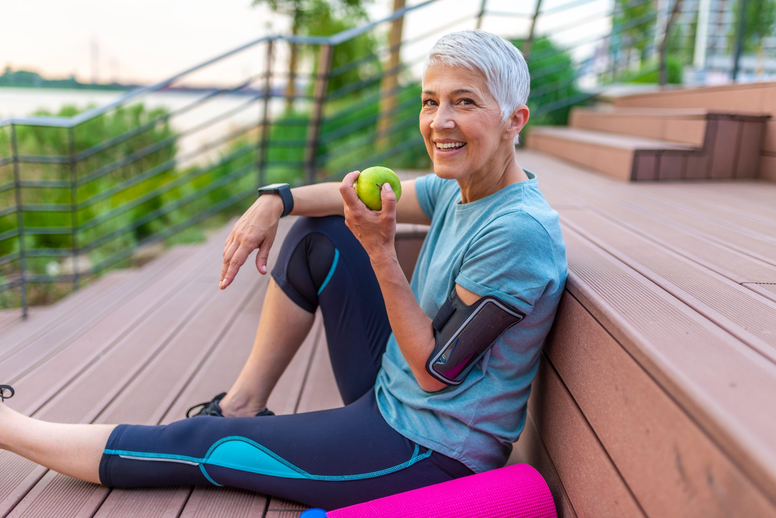woman sat eating healthily after workout